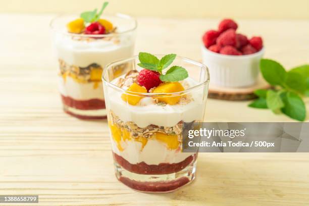 homemade mango and raspberry with yogurt and granola - blended drink stock pictures, royalty-free photos & images