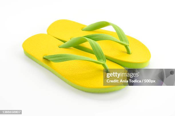 rubber slippers,close-up of yellow sandals over white background - red flip flops isolated stock pictures, royalty-free photos & images