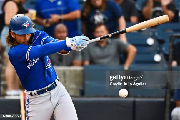 Bo Bichette of the Toronto Blue Jays hits a single in the first inning against the New York Yankees during a Grapefruit League spring training game...