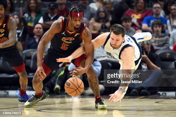 Nembhard Jr. #5 of the Cleveland Cavaliers and Luka Doncic of the Dallas Mavericks battle for a loose ball during the fourth quarter at Rocket...
