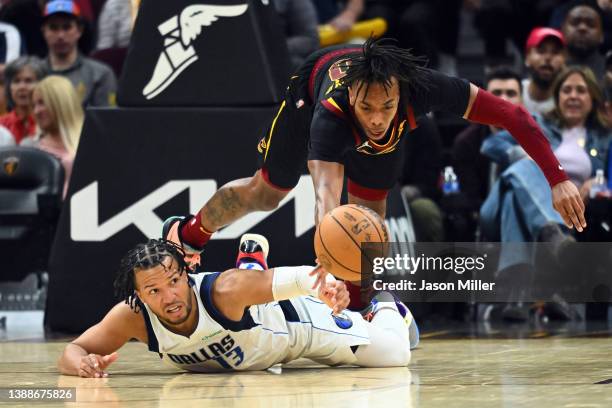 Jalen Brunson of the Dallas Mavericks and Darius Garland of the Cleveland Cavaliers dive for a loose ball during the fourth quarter at Rocket...