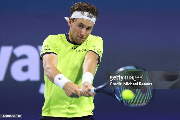 Casper Ruud of Norway returns a shot to Alexander Zverev of Germany during the Miami Open at Hard Rock Stadium on March 30, 2022 in Miami Gardens,...