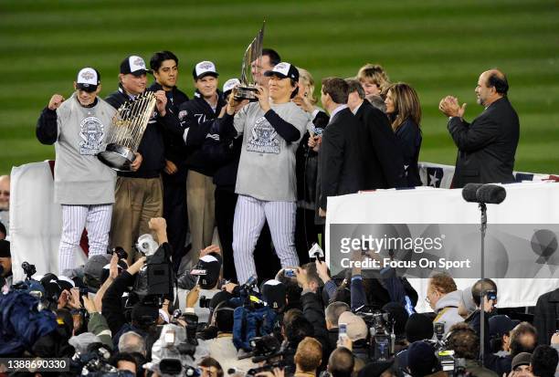 Hideki Matsui of the New York Yankees celebrates with the Most Valuable Player trophy after receiving the award for being the MVP in the World Series...