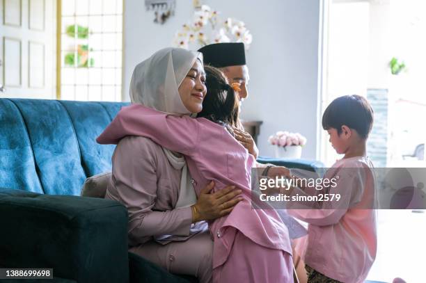 Muslim Malays family embraces during Hari Raya Puasa celebration