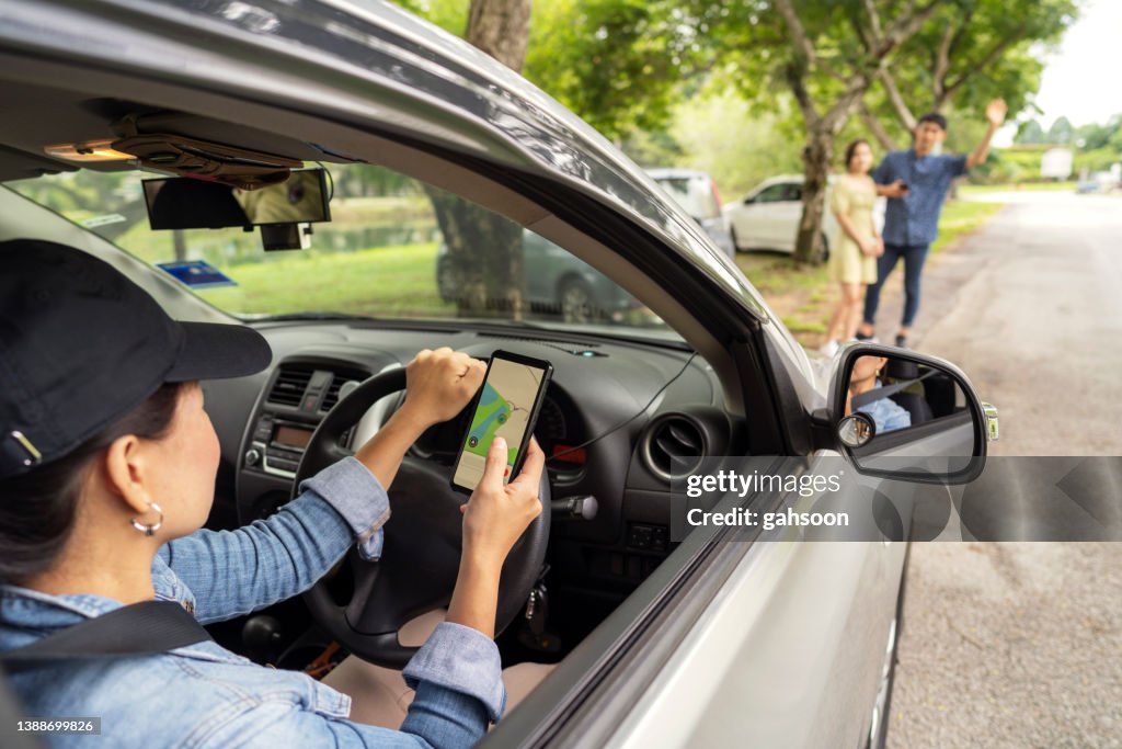 Rideshare taxi approaching customer at roadside