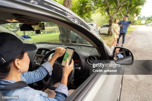 rideshare taxi approaching customer at roadside - driver rider stock pictures, royalty-free photos & images