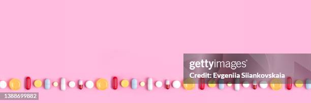 web banner with different pills on pink background. close-up. - tablette stock-fotos und bilder