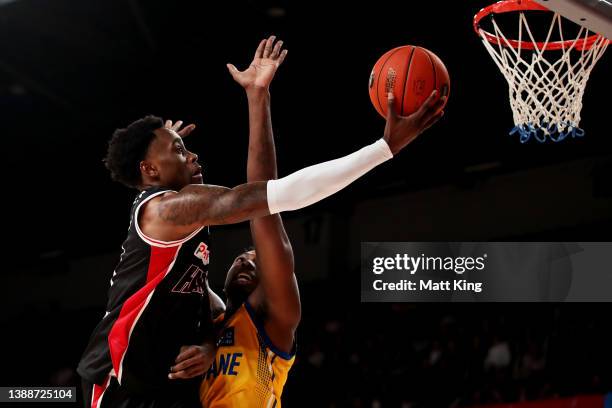 Antonius Cleveland of the Hawks drives to the basket under pressure from Robert Franks of the Bullets during the round eight NBL match between...