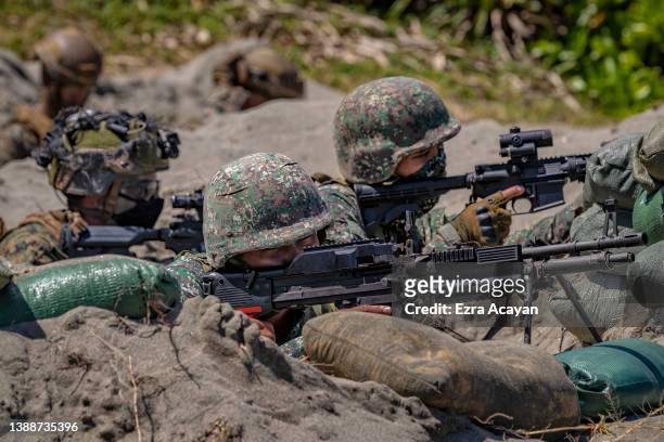 And Philippine marines take part in a joint amphibious assault exercise as part of the annual 'Balikatan' US-Philippines war exercises, off the...