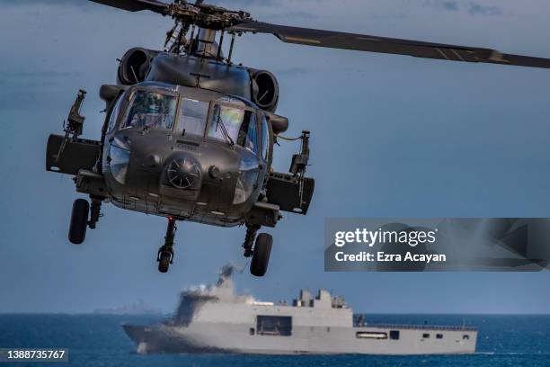 Philippine Black Hawk helicopter takes off as US and Philippine marines take part in a joint amphibious assault exercise as part of the annual...