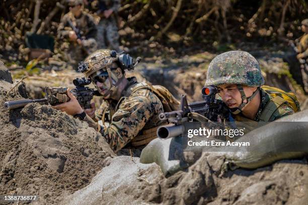 And Philippine marines take part in a joint amphibious assault exercise as part of the annual 'Balikatan' US-Philippines war exercises, off the...