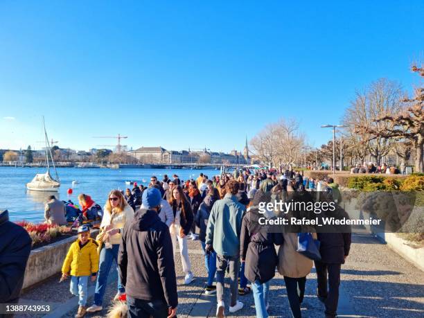 people walking next to the lake zurich - lake zurich switzerland stock pictures, royalty-free photos & images