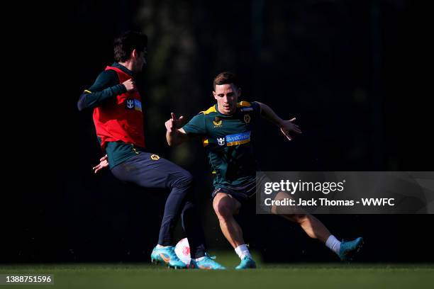 Francisco Trincao battles for possession against Daniel Podence of Wolverhampton Wanderers during a Wolverhampton Wanderers Training Session at The...