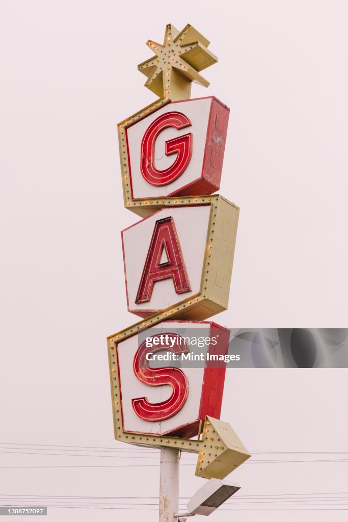 A retro style GAS station sign, red lettering road sign.