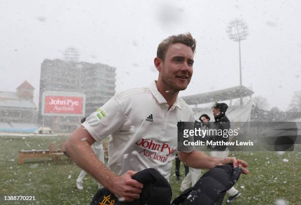 Stuart Broad of Nottinghamshire CCC runs to take cover from falling snow during the Nottinghamshire CCC Photocall at Trent Bridge on March 31, 2022...