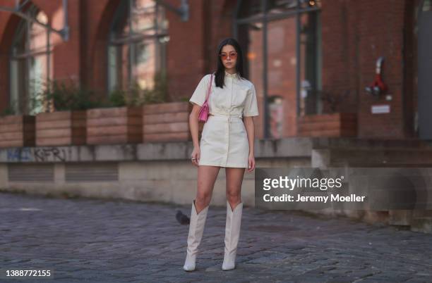 Antonia Sophie seen wearing a off-white/light beige button up denim short dress from LeGer, a pink sunglasses from Chimi Eyewear, a pink Jacquemus...