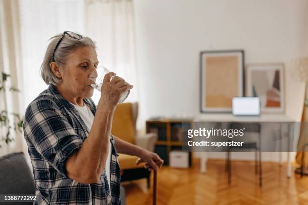thirsty senior woman - drinking water stock pictures, royalty-free photos & images