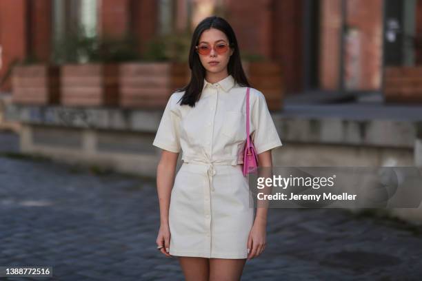 Antonia Sophie seen wearing a off-white/light beige button up denim short dress from LeGer, a pink sunglasses from Chimi Eyewear and a pink Jacquemus...