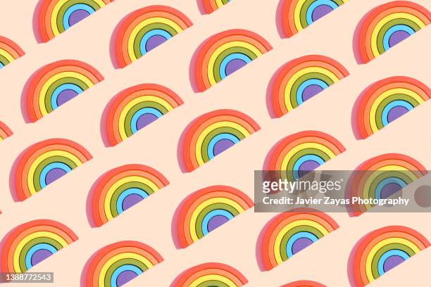 some rainbow shaped and colored puzzle toys on pastel background - communities in schools annual celebration stock pictures, royalty-free photos & images