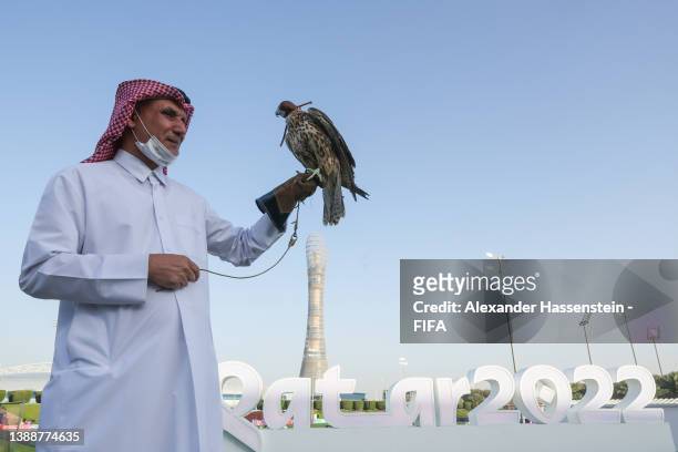 Falcon, the national bird of Qatar is held in front of a Qatar 2022 sign ahead of the 72nd FIFA Congress Football Delegation Tournament at Aspire...