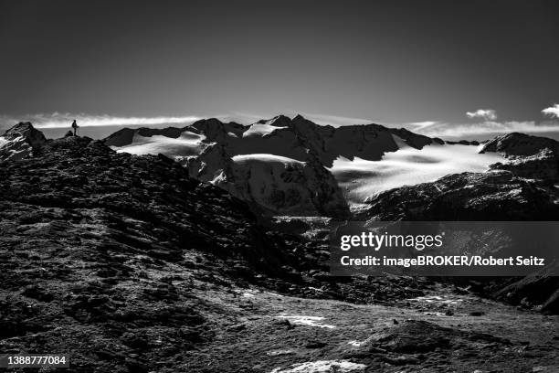 climber on rocky outcrop with south tyrolean mountains at blue hour, martell valley, naturno, south tyrol, italy - martell valley italy - fotografias e filmes do acervo