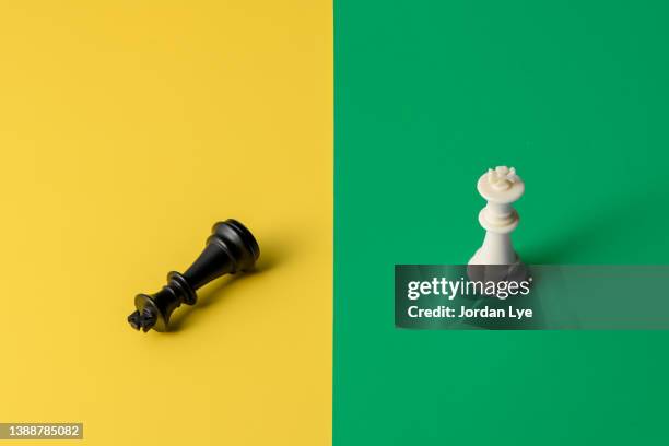 close-up of kings chess piece on color background - chess defeat stock pictures, royalty-free photos & images