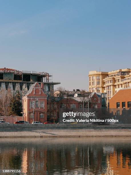 moscow by valeria nikitina,view of buildings by river against sky,russia - nikitina stock pictures, royalty-free photos & images