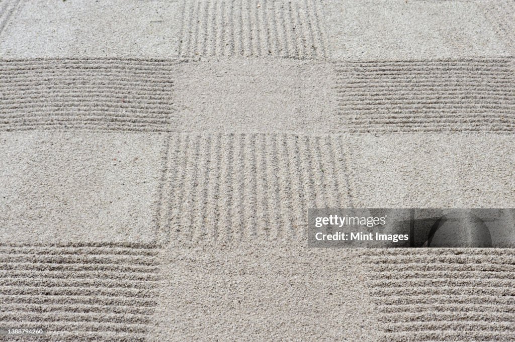 Grid pattern of raked gravel at a temple
