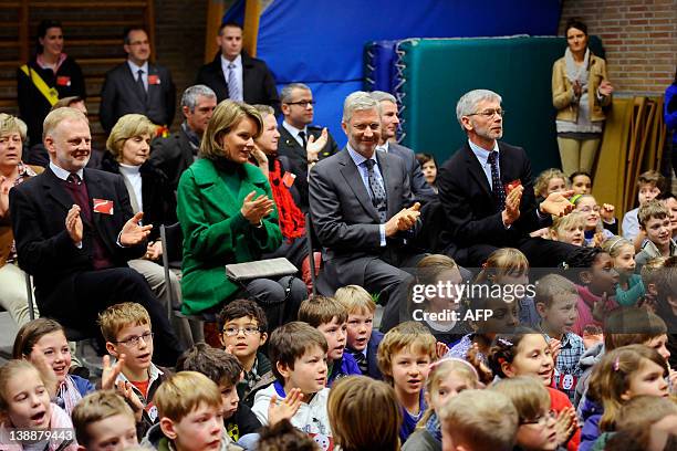 Belgium's Princess Mathilde of Belgium and Crown Prince Philippe applaud on February 13, 2012 during a visit to the Sint Pieters instituut Zevendonk,...