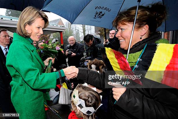 Belgium's Princess Mathilde shakes hands with a wellwisher on February 13, 2012 as she arrives at the Sint Pieters instituut Zevendonk, BLOOS-project...