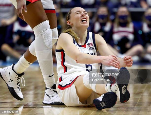 Paige Bueckers of the UConn Huskies reacts after colliding with Grace Berger of the Indiana Hoosiers in the first half during the Sweet Sixteen round...