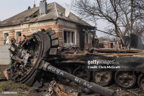 Destroyed Russian tank is seen in front of a damaged house on March 31, 2022 in Malaya Rohan, Ukraine. A Ukrainian commander said last Friday that...