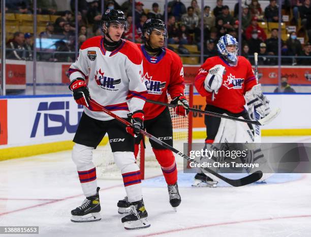 Matyas Sapovaliv of Team White battles for position with Isaiah George of Team Red in the 2022 CHL/NHL Top Prospects Game at Kitchener Memorial...