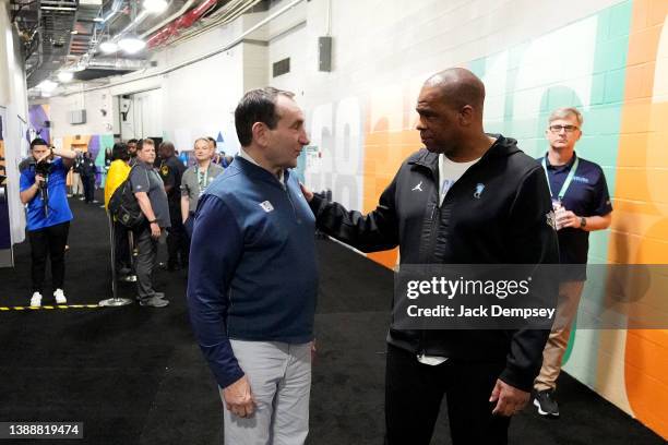 Head coach Mike Krzyzewski of the Duke Blue Devils talks with head coach Hubert Davis of the North Carolina Tar Heels during Media Day for the NCAA...