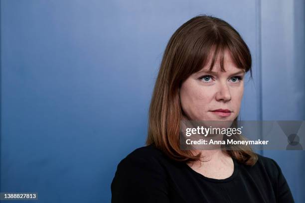 White House Communications Director Kate Bedingfield listens as White House National Economic Council Director Brian Deese speaks to reporters during...