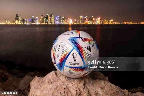 In this photo illustration an official FIFA World Cup Qatar 2022 ball sits on display in front of the skyline of Doha ahead of the FIFA World Cup...