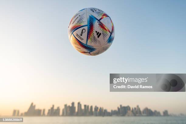 In this photo illustration an official FIFA World Cup Qatar 2022 ball sits on display in front of the skyline of Doha ahead of the FIFA World Cup...