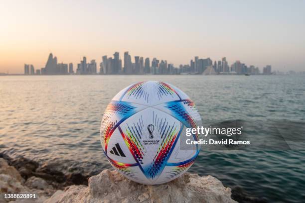 In this photo illustration an official FIFA World Cup Qatar 2022 ball sits on display in front of the skyline of Doha ahead of the FIFA World Cup...