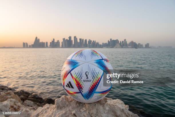 In this photo illustration an official FIFA World Cup Qatar 2022 ball sits on display in front of the skyline of Doha ahead of the FIFA World Cup...