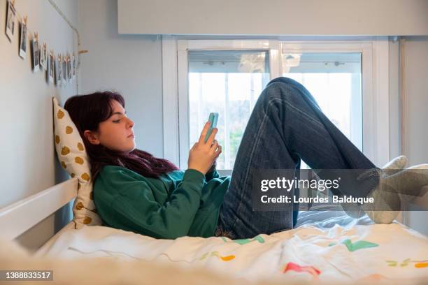 teenager in bed with mobile - spain madrid madrid girls stock pictures, royalty-free photos & images