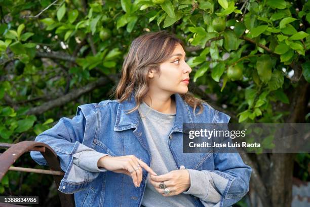 summer portrait of happy young woman wearing denim jacket - denim jacket stock pictures, royalty-free photos & images