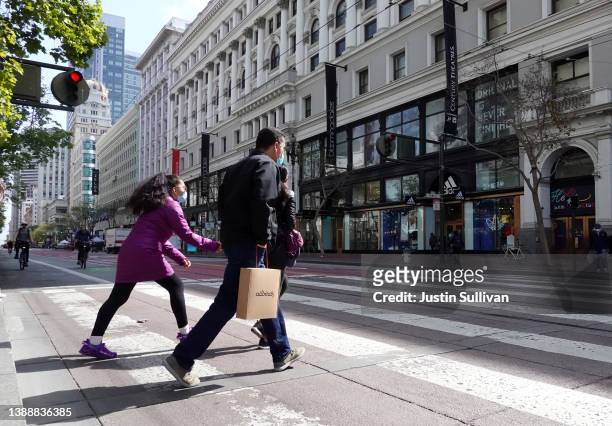 Shopper carries a shopping bag while walking through the Union Square shopping district on March 31, 2022 in San Francisco, California. According to...
