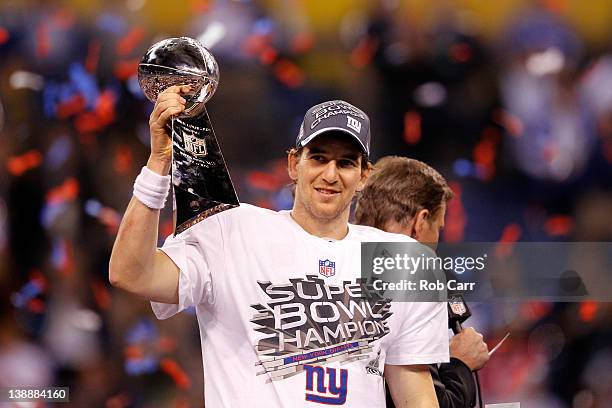 Eli Manning of the New York Giants celebrates with the Vince Lombardi trophy after the Giants won 21-17 against the New England Patriots during Super...