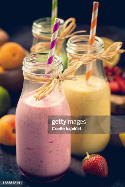 freshly blended fruit smoothies - yellow smoothie stock pictures, royalty-free photos & images