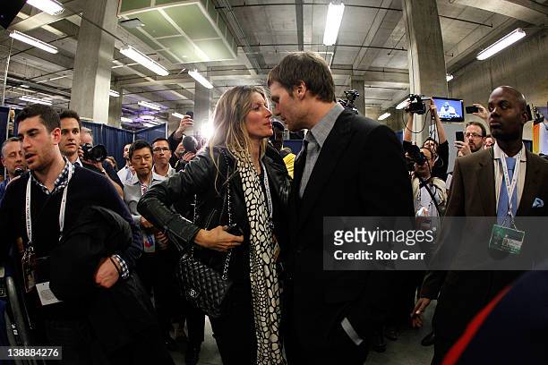 Tom Brady of the New England Patriots chats with his wife Gisele Bundchen speak in the press conference area after the Patriots lost 21-17 against...