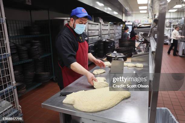 Arturo Sanchez prepares dough to be used in Chicago-style deep dish pizza at a Lou Malnati's restaurant on March 31, 2022 in Chicago, Illinois....