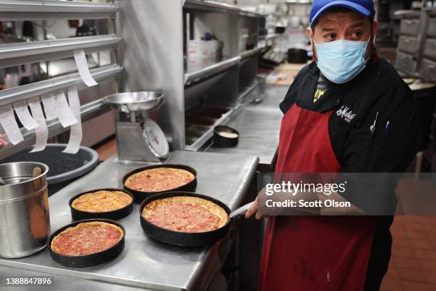 Arturo Sanchez makes Chicago-style deep dish pizza at a Lou Malnati's restaurant on March 31, 2022 in Chicago, Illinois. Restaurants, like the...