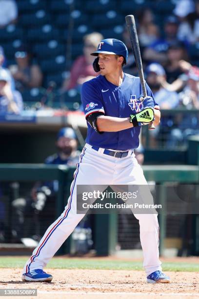 Corey Seager of the Texas Rangers bats against the Los Angeles Dodgers during the second inning of the MLB spring training game at Surprise Stadium...