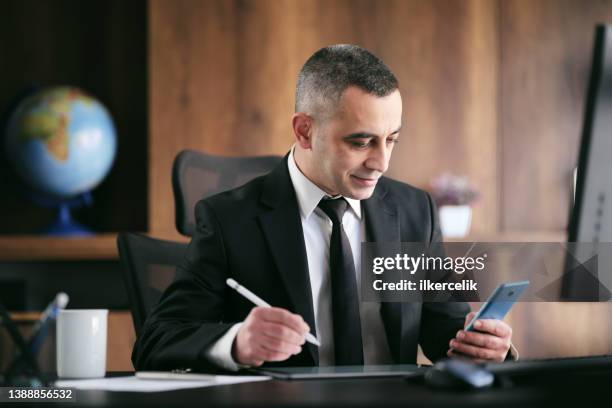 businessman having a distant business meeting via virtual reality headset in the office. metaverse concept. - electronic form stock pictures, royalty-free photos & images