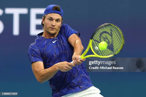 Miomir Kecmanovic of Serbia returns a shot to Carlos Alcaraz of Spain during the Miami Open at Hard Rock Stadium on March 31, 2022 in Miami Gardens,...